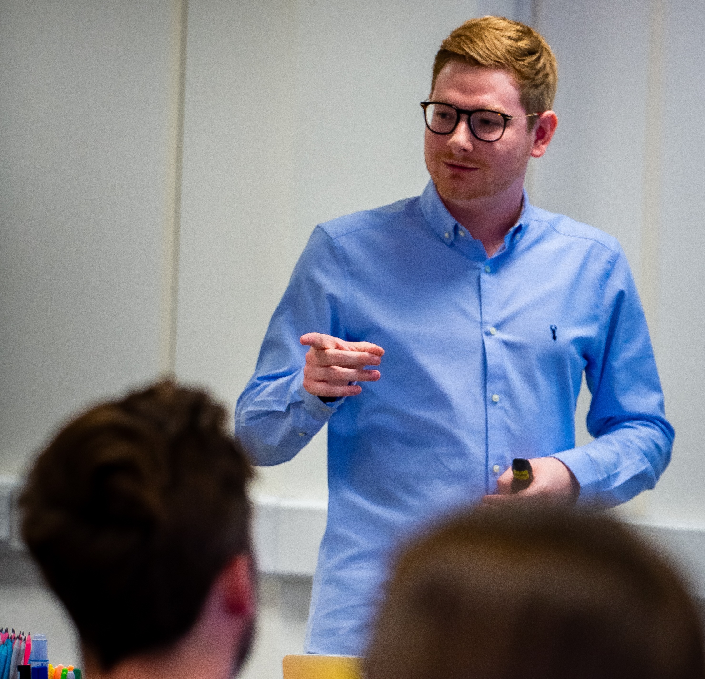 Tom Wardman speaking to a room, seen from behind the audience
